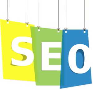 Three colored paper sheets (yellow, green, blue) hang from strings, each with a large white letter spelling SEO from left to right. The sheets are overlapped and have drop shadows.